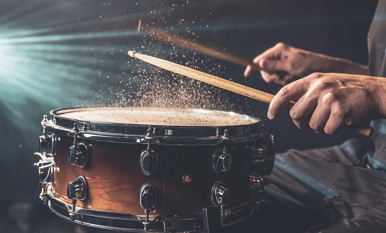 Drummer Using Drum Sticks Hitting Snare Drum With Splashing Water Black Background Studio Lighting Close Up